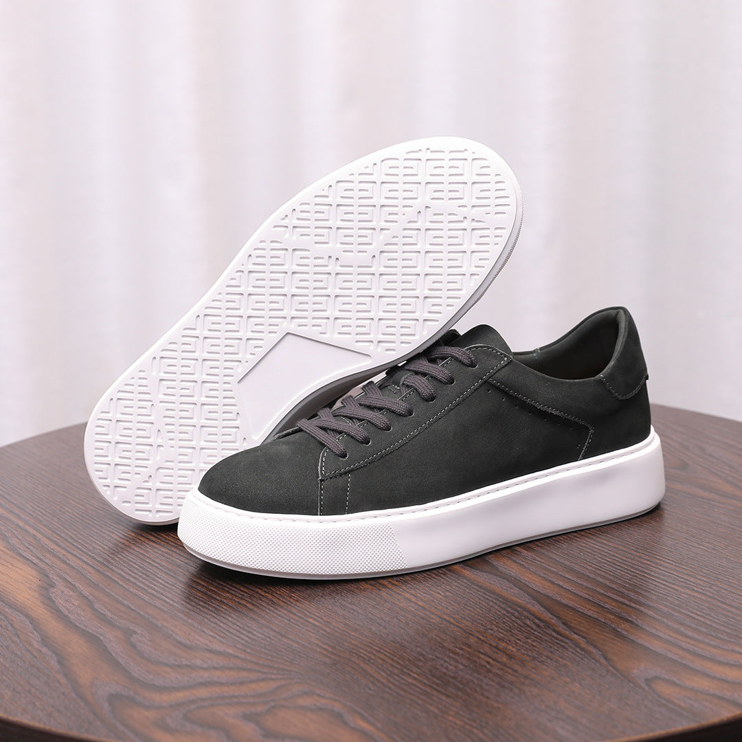 Charcoal gray leather sneakers with textured sole visible, lace-up style