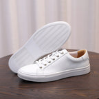 Men's white leather sneaker with lace-up upper and textured rubber outsole