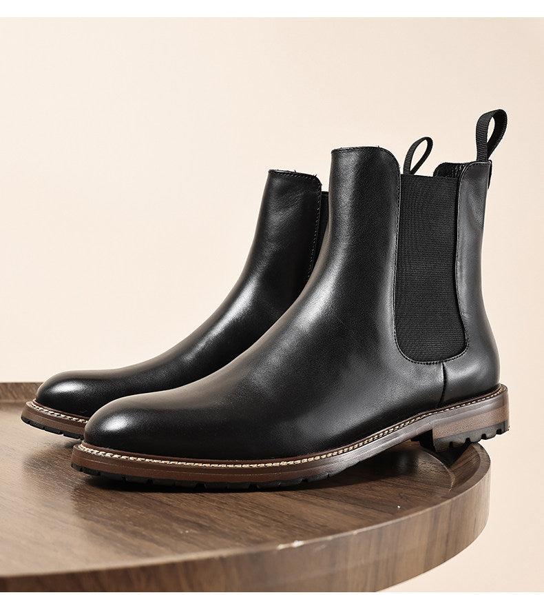Black leather Chelsea dress boots with elastic side panels and stitched outsole