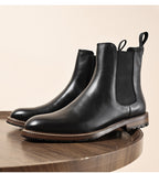 Black leather Chelsea dress boots with elastic side panels and stitched outsole