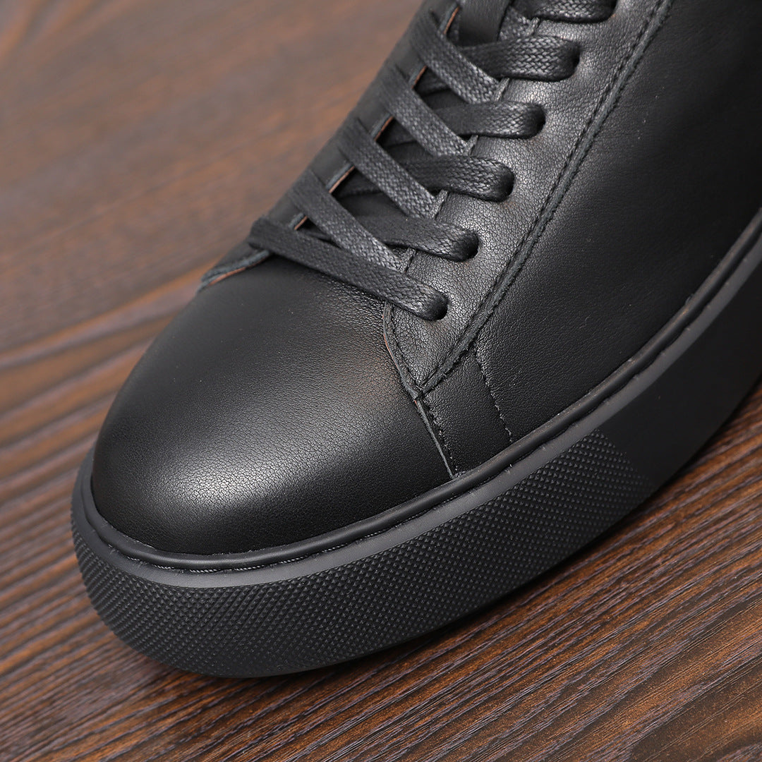 Black leather sneaker close-up, lace-up detail and textured rubber edge trim
