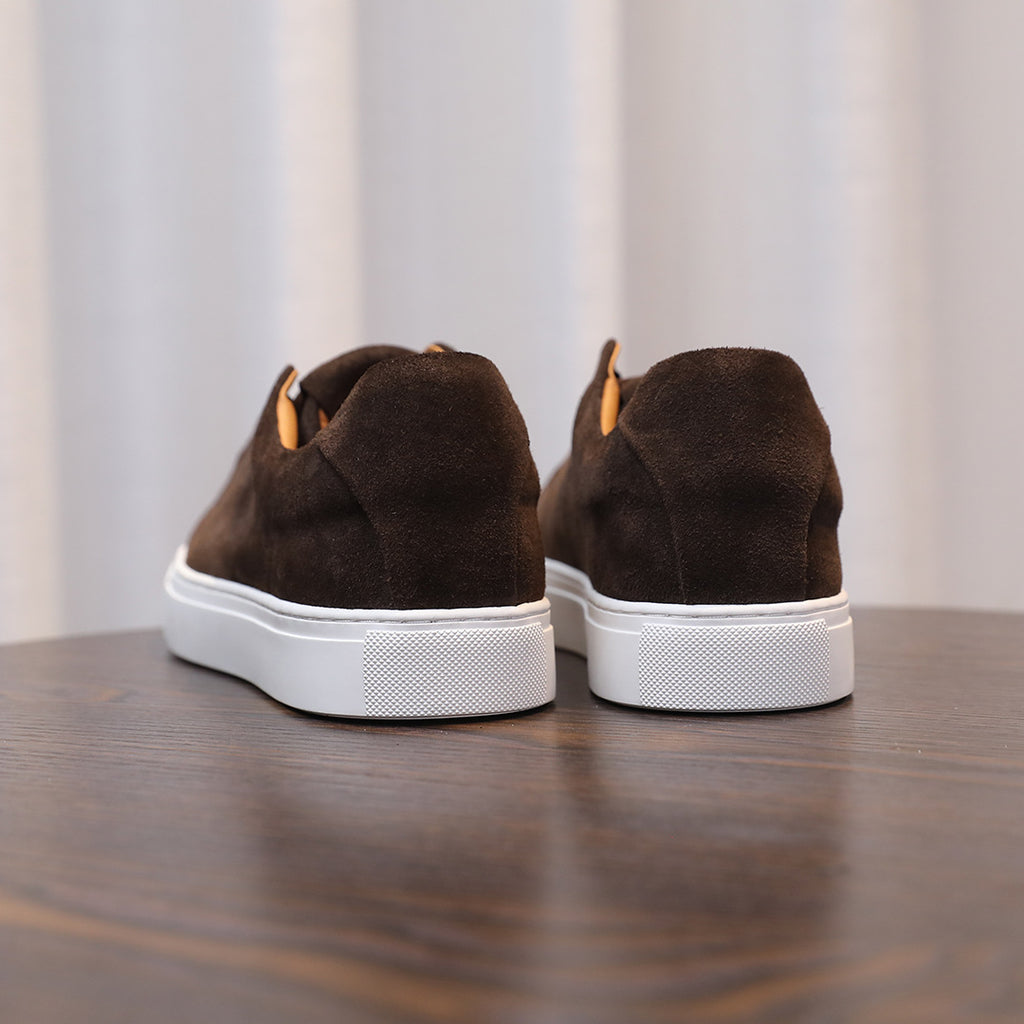 Men's brown suede leather sneakers, rear view with white rubber heel trim