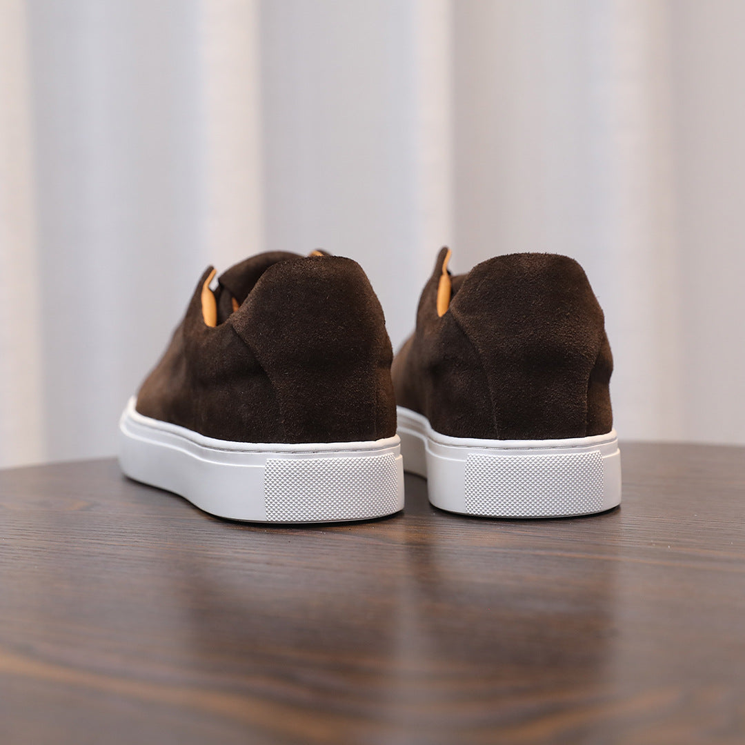 Men's brown suede leather sneakers, rear view with white rubber heel trim