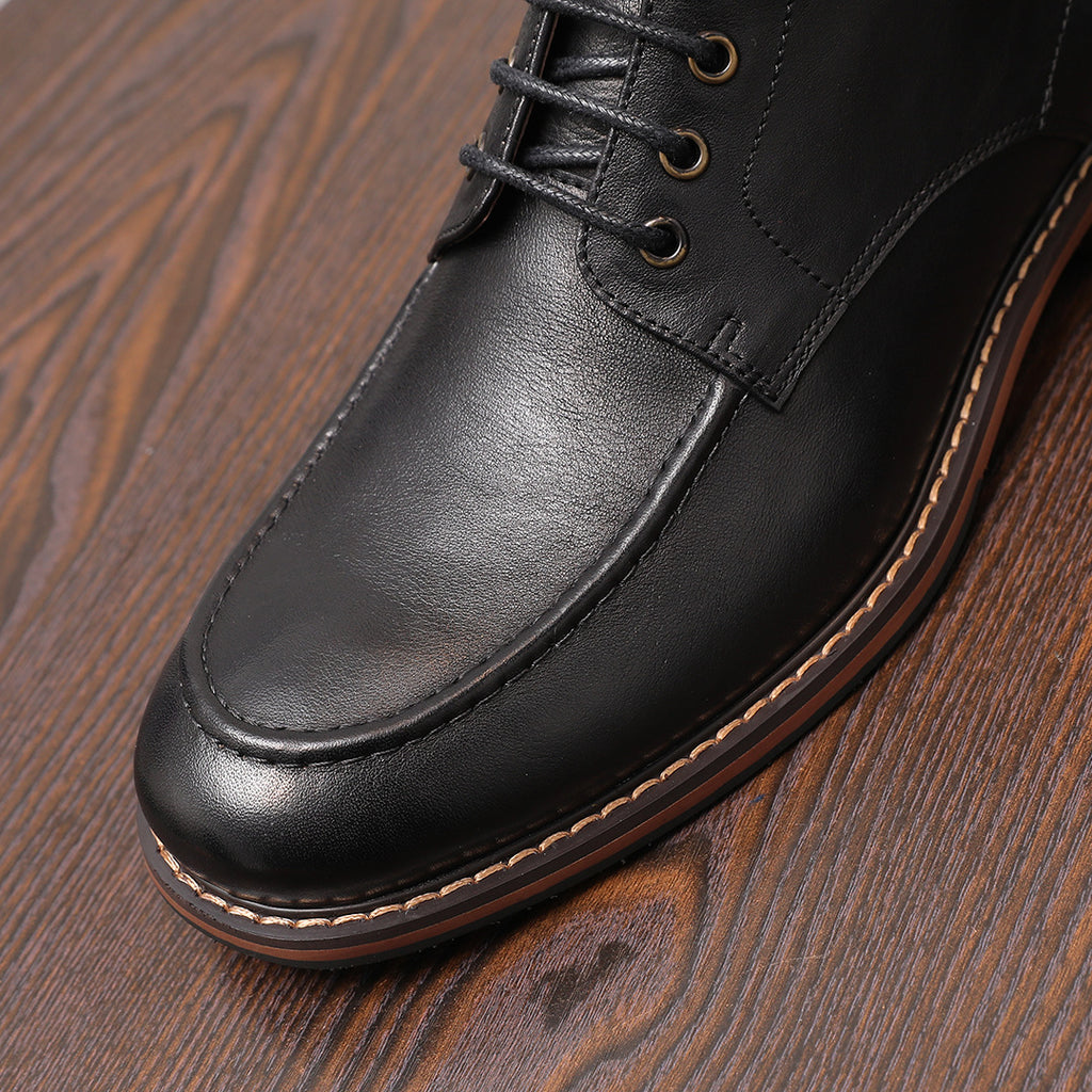 Black leather pointed-toe dress boot with lace-up front and side zipper