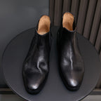 Pointed-toe suede Chelsea dress boots in black with tan interior lining