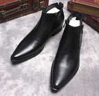 Men's black leather side-zip dress boots with thick sole, pair view on display