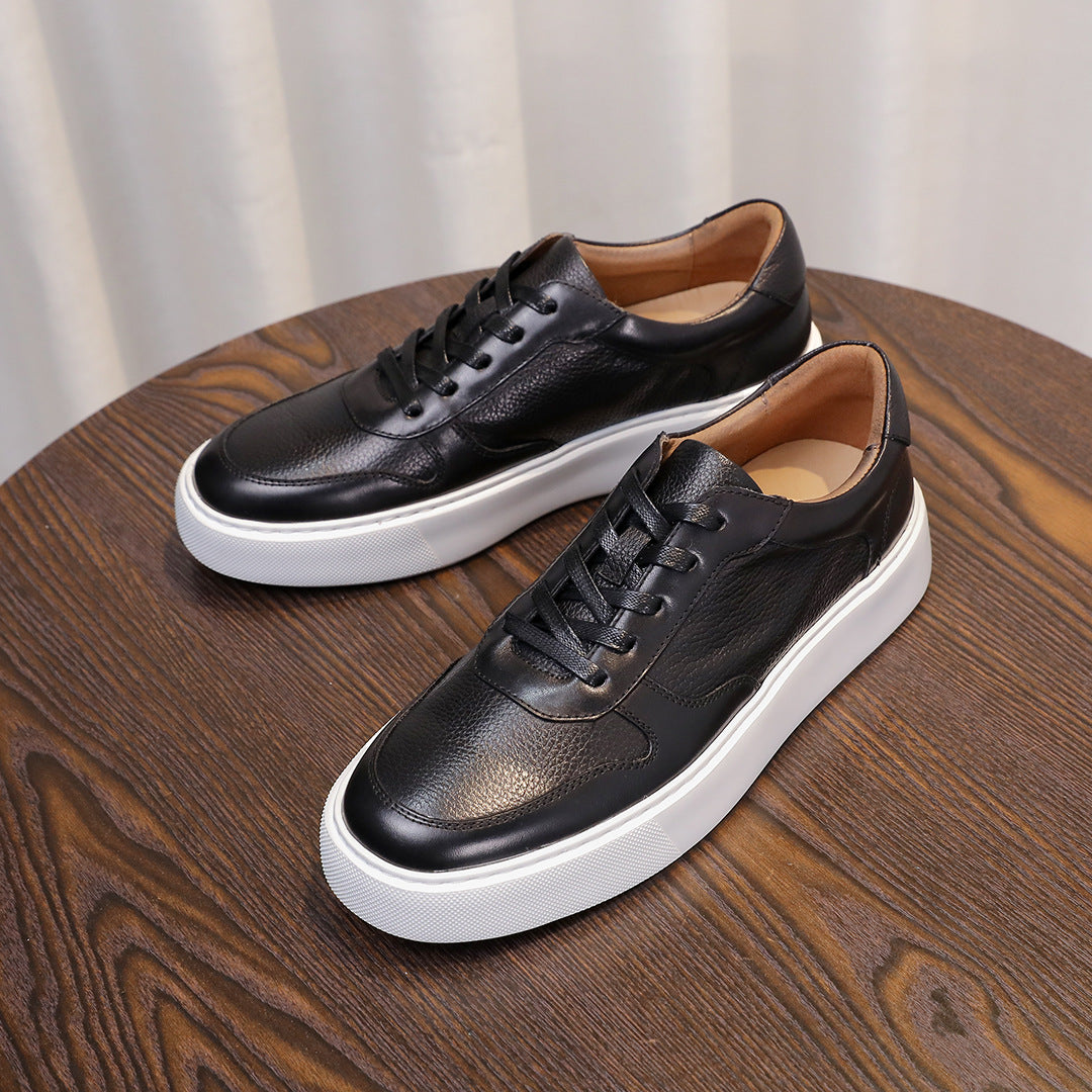 Black leather lace-up sneakers with white rubber sole and low-profile minimalist design