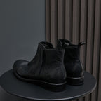 Black leather side-zip dress boots with elastic gore panels and low heel