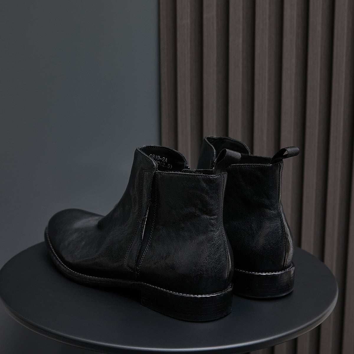 Black leather side-zip dress boots with elastic gore panels and low heel