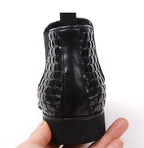 Black leather boot heel and back with woven trim and side zipper panel, thick sole