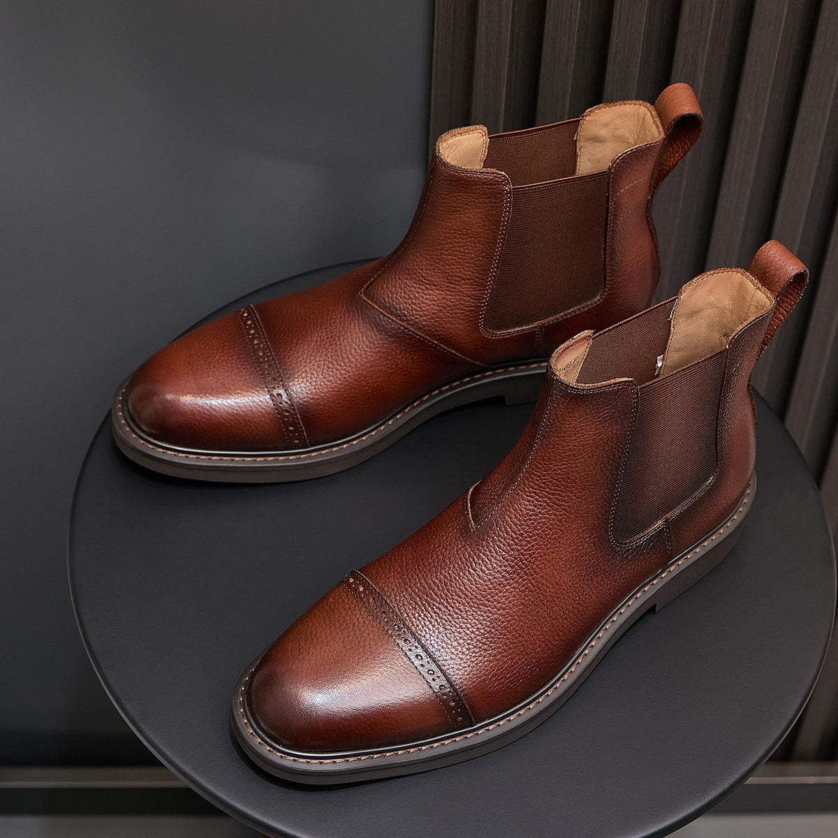 Brown Chelsea dress boots with pointed toe, elastic gore, and textured sole