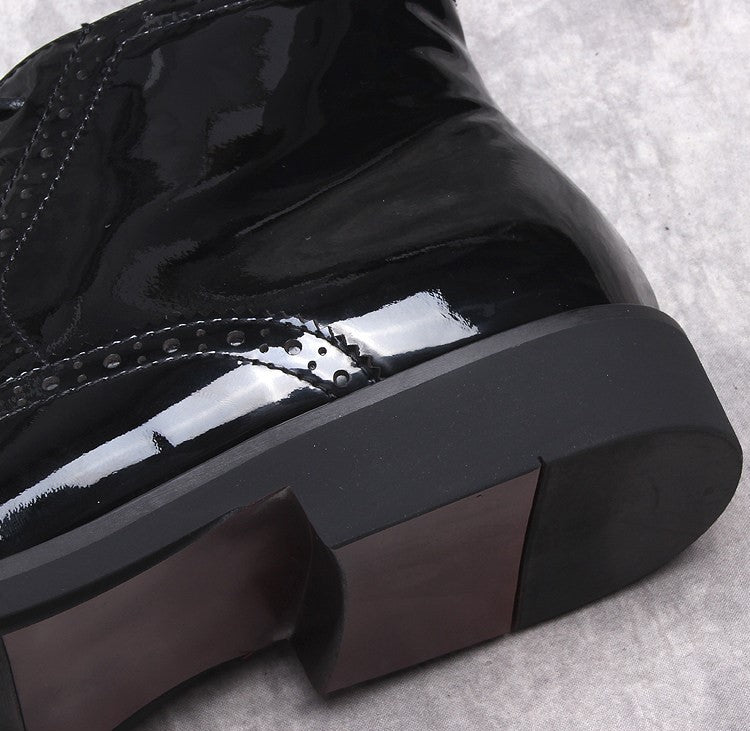 Men's black formal dress boots close-up: thick block heel with glossy toe