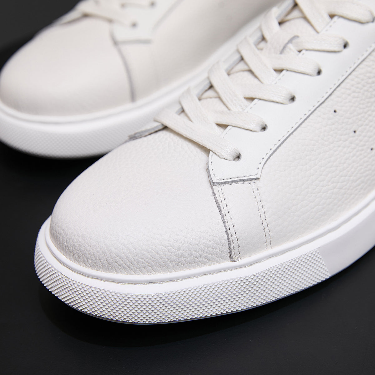 White genuine leather sneaker toe and side, lace-up with grippy rubber platform sole
