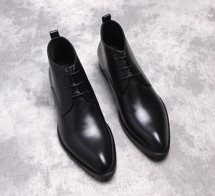 Black lace-up dress boots with cap-toe stitching and low heel