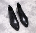 Black lace-up dress boots with cap-toe stitching and low heel