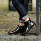 Black leather pointed-toe ankle boots with side zipper and stacked sole