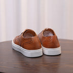 Men's brown leather sneakers back view with white rubber sole and heel panel