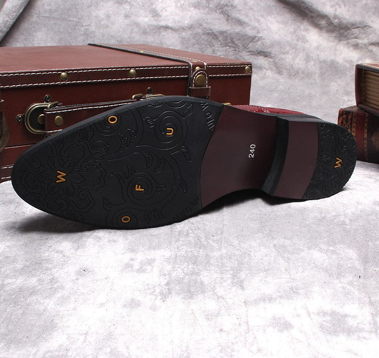 Black boot outsole view with tread pattern and small embossed logos on heel