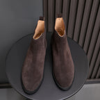 Men's pointed-toe suede Chelsea dress boots, dark brown, front view on stand