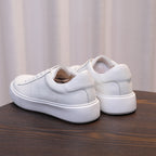 Men's leather sneakers, white, rear view showing back pull tab and cushioned heel