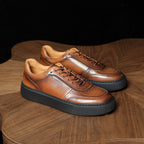 Brown leather lace-up sneakers with glossy panels and thick black platform sole.