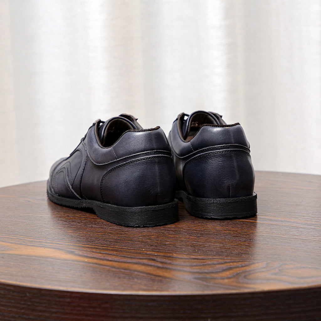 Men's dark gray leather sneakers, rear view with cushioned heel and rubber sole