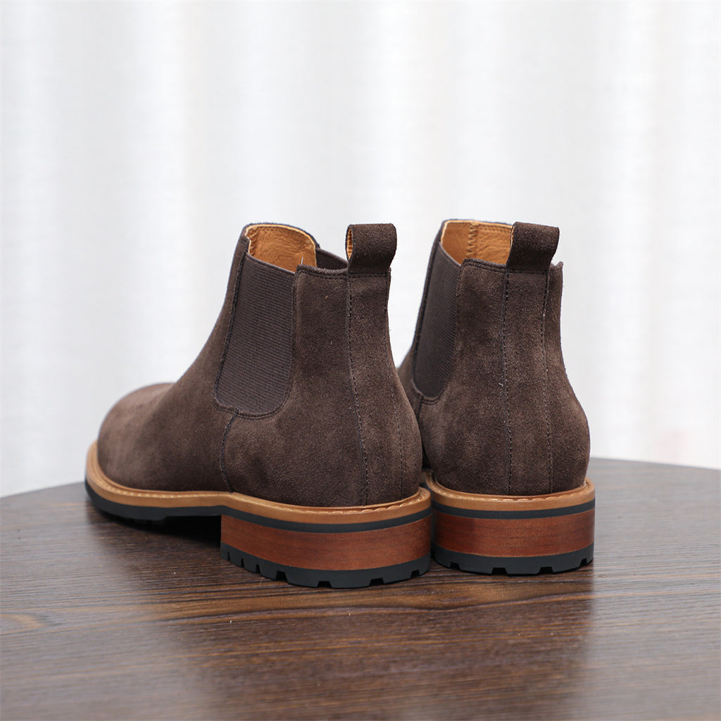 Pair of dark brown suede pointed-toe Chelsea dress boots with elastic side gore.