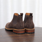 Pair of dark brown suede pointed-toe Chelsea dress boots with elastic side gore.