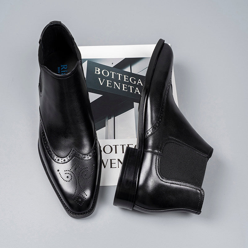 Black leather slip-on Chelsea dress boots with elastic side panels and brogue detailing