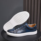 Navy leather sneaker outsole with textured tread, shown with white sole edge
