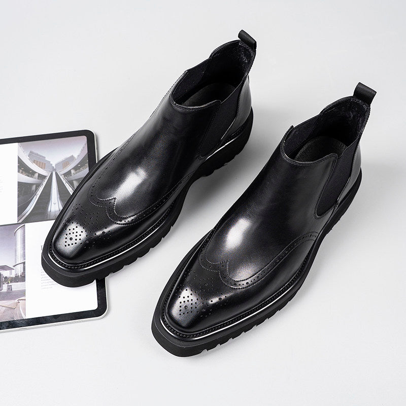Black leather Chelsea dress boots with perforated toe and elastic side gore panels