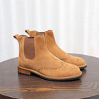 Brown suede pointed-toe Chelsea boots with elastic gore and decorative perforated detailing