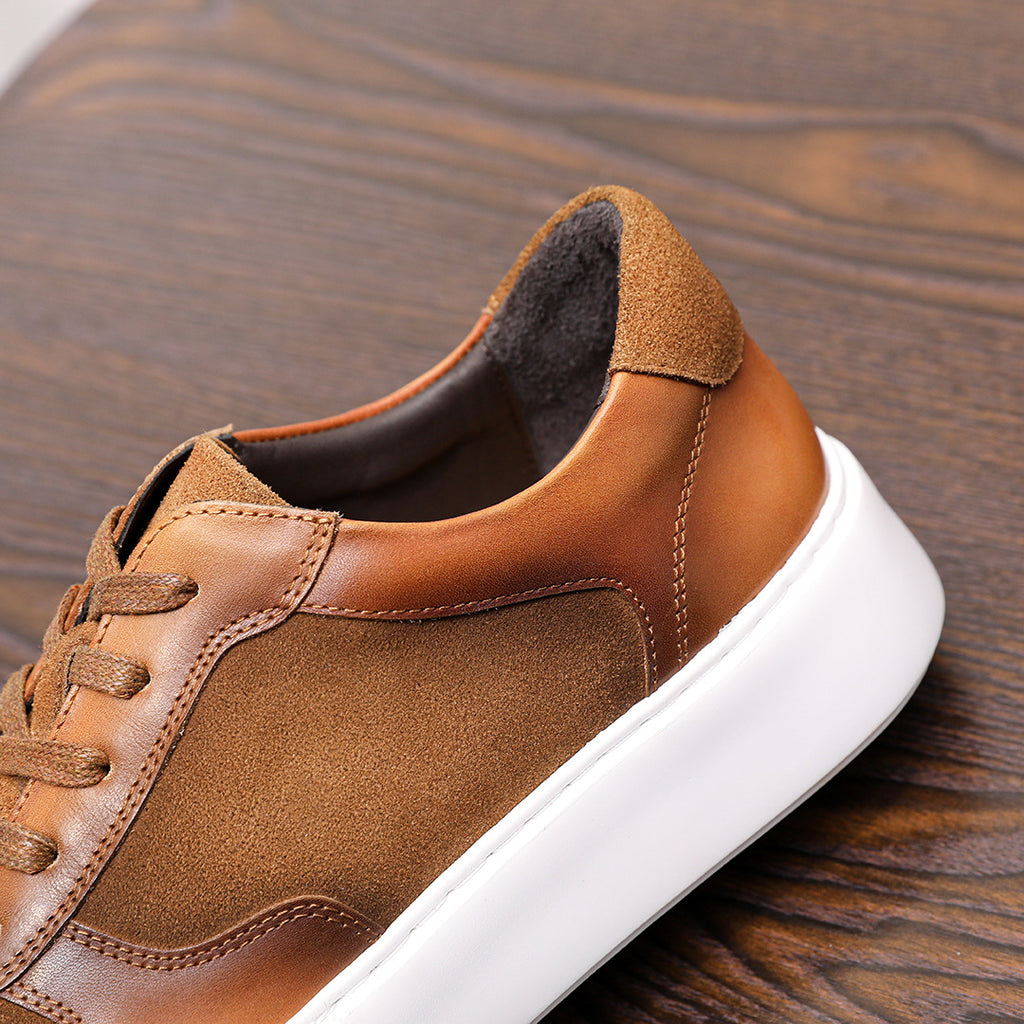 Brown leather sneaker heel with padded collar lining and white rubber sole