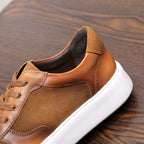 Brown leather sneaker heel with padded collar lining and white rubber sole