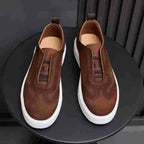Brown leather sneakers, slip-on style with textured upper and white sole