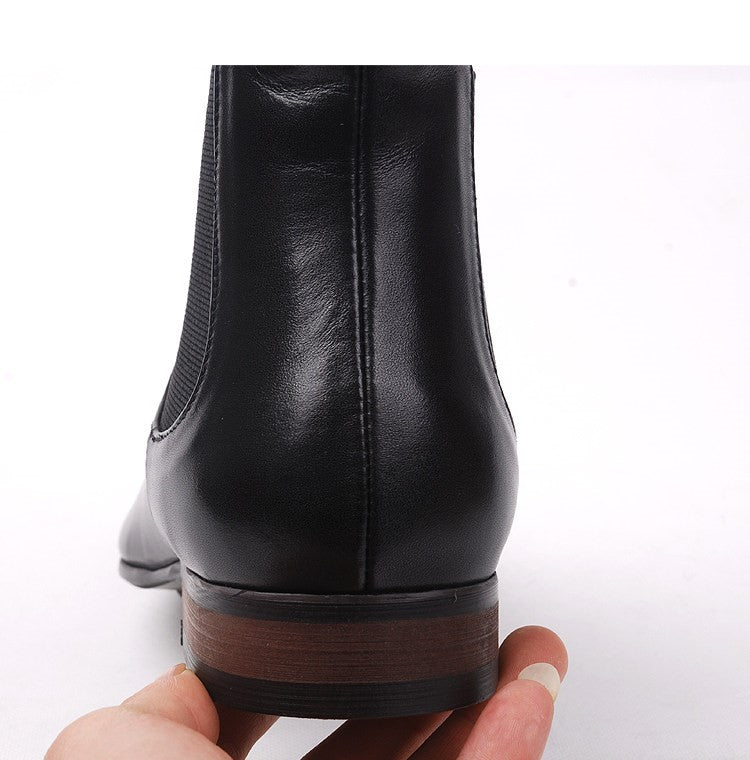 Close-up of black Chelsea boot heel with ribbed sole edge and stitched detail.