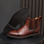 Brown Chelsea dress boots with pointed toe, side elastic panels, and cushioned lining