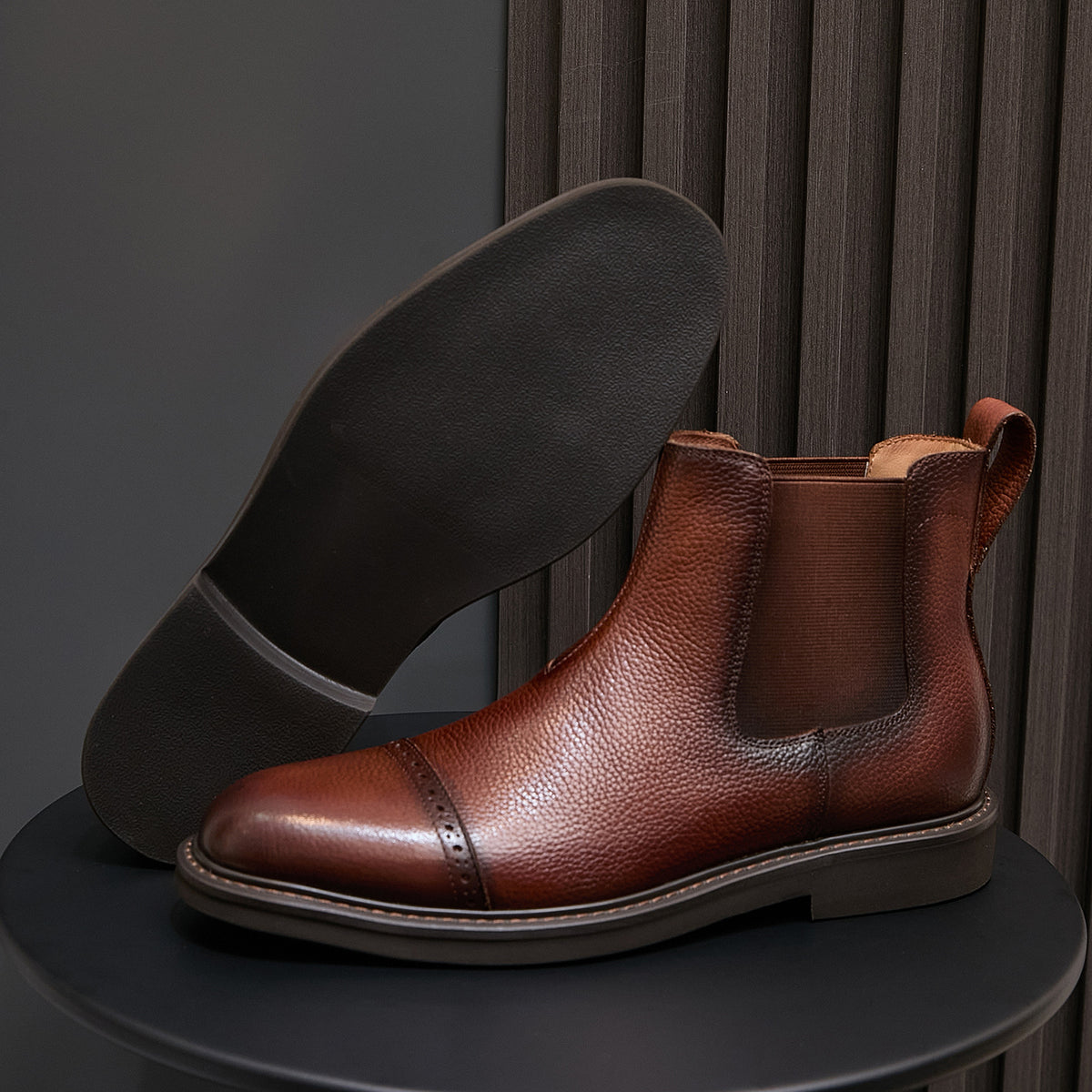Brown Chelsea dress boots with pointed toe, side elastic panels, and cushioned lining