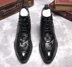 Black lace-up dress boots, front view with wingtip stitching and shiny leather finish