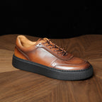 Brown genuine leather sneakers with lace-up front and thick dark rubber sole