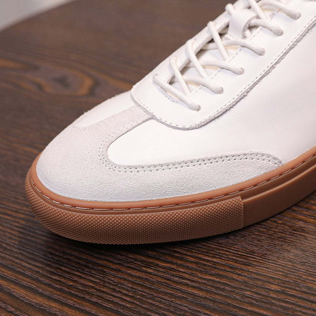 White genuine leather lace-up sneakers with tan rubber sole and side panel stitching