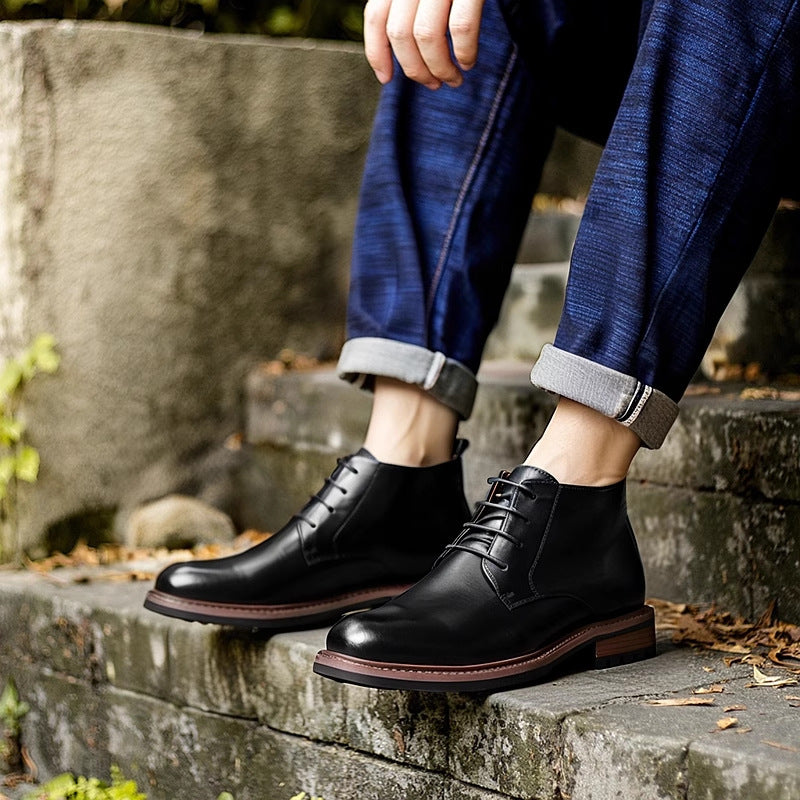Black men's leather lace-up chukka boots with plain toe and padded collar.