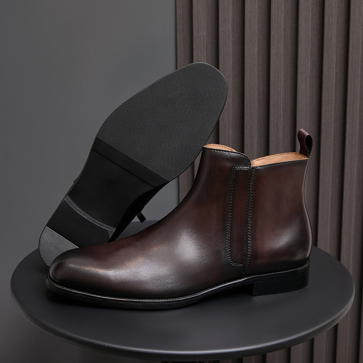 Men's pointed-toe leather dress boots with side zip, black finish and black sole.