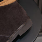 Men's dark brown suede chukka boot side with contrast-trimmed sole and laces