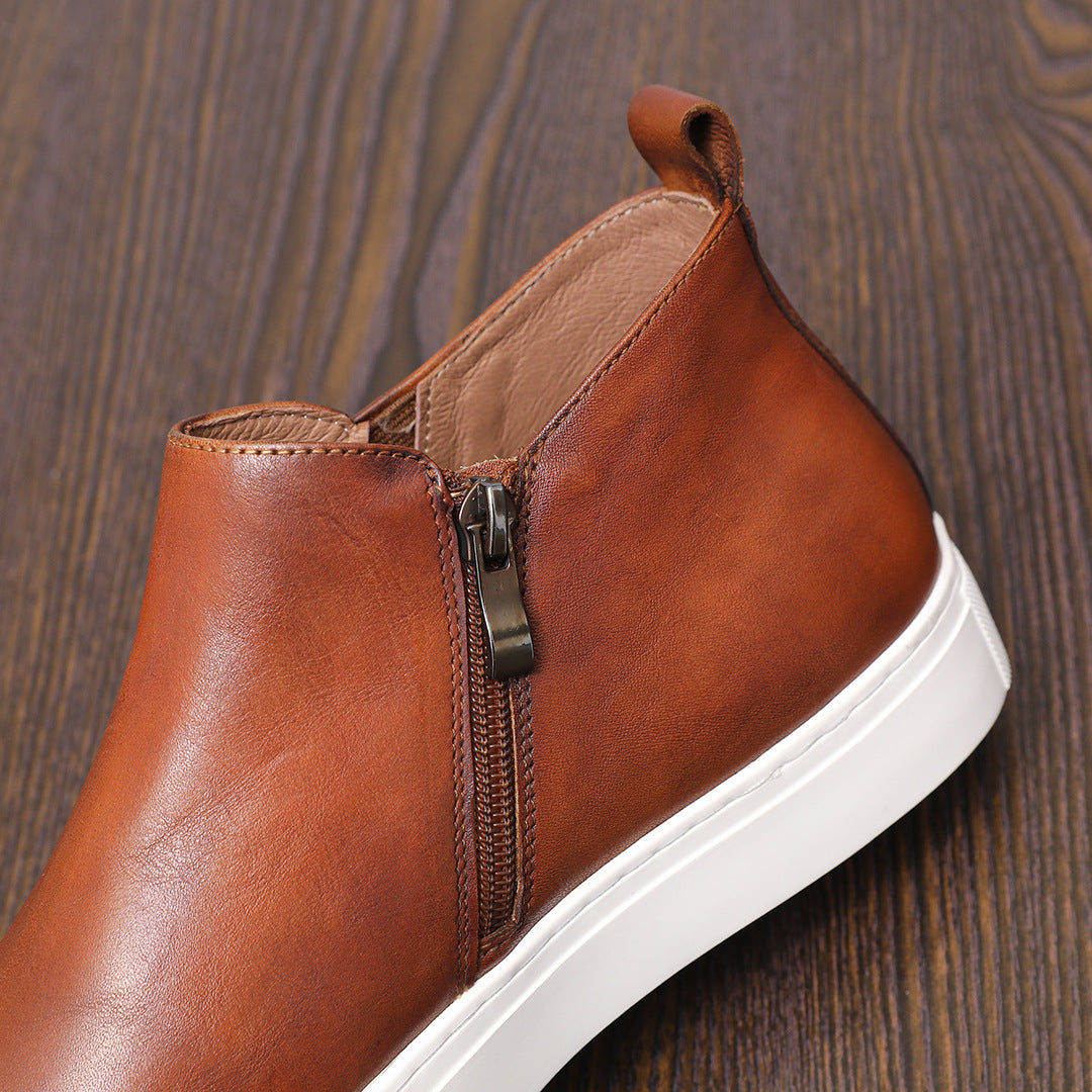 Brown leather ankle boot with side zipper, pointed toe, and white platform sole