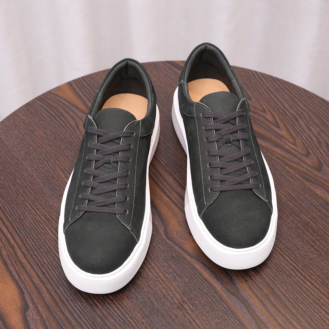 Pair of black leather low-top sneakers with purple-gray laces and white sole