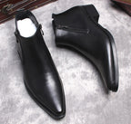 Men's black leather dress boots with side zip, thick sole, pointed toe.