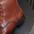Men's brown leather ankle boots with stitched side panel and black rubber sole
