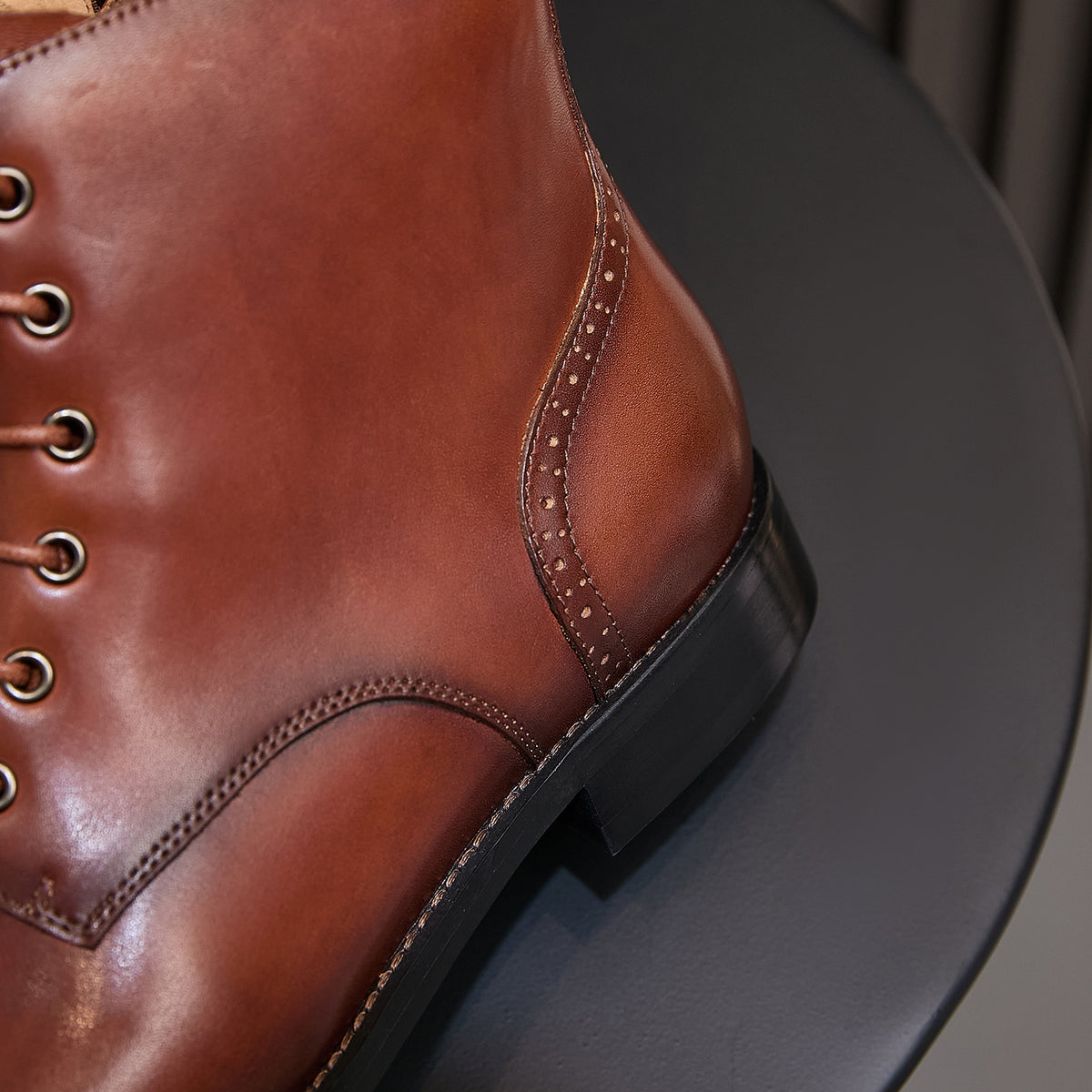 Men's brown leather ankle boots with stitched side panel and black rubber sole