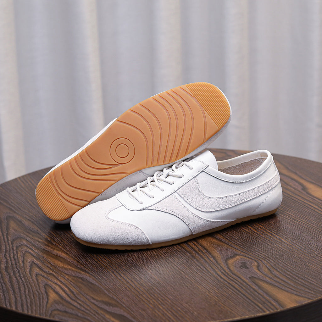 Men's white leather sneakers with lace-up front and gum rubber sole